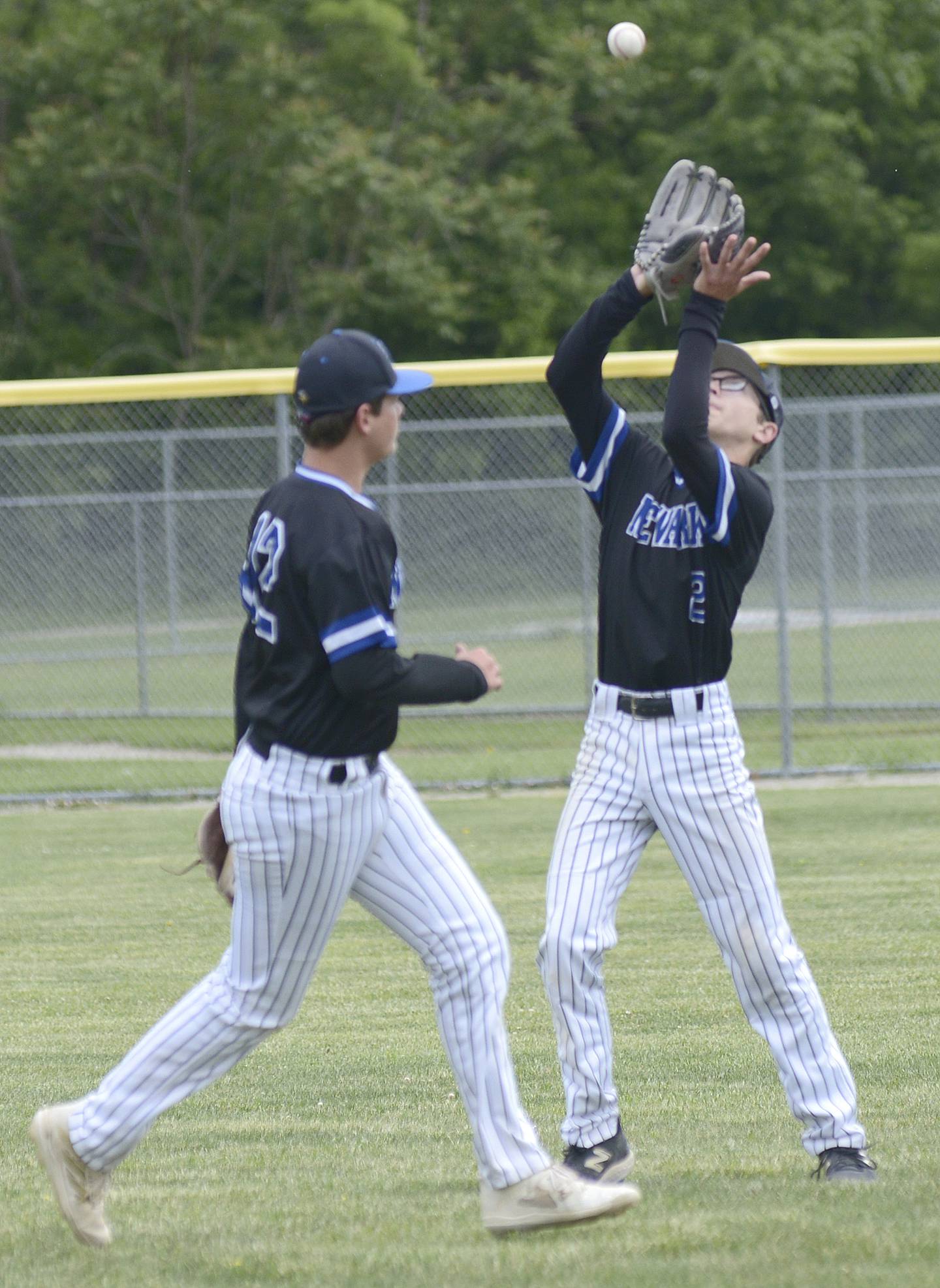Newark’s Jacob Seyller sets to haul in a fly ball in right as team mate Jackson Walker looks on Saturday agains Marquette at Masinelli Field.