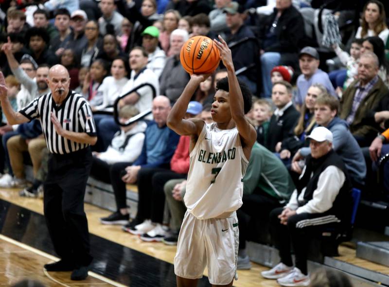 Glenbard West's TJ Williams shoots three points during the Class 4A St. Charles East Sectional final against Geneva on Friday, March 7, 2025 in St. Charles.