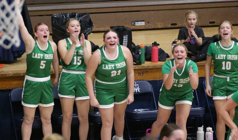 Members of the Seneca girls basketball team cheer on the Irish while playing Marquette on Thursday, Dec. 5, 2024 in Bader Gym at Marquette High School.