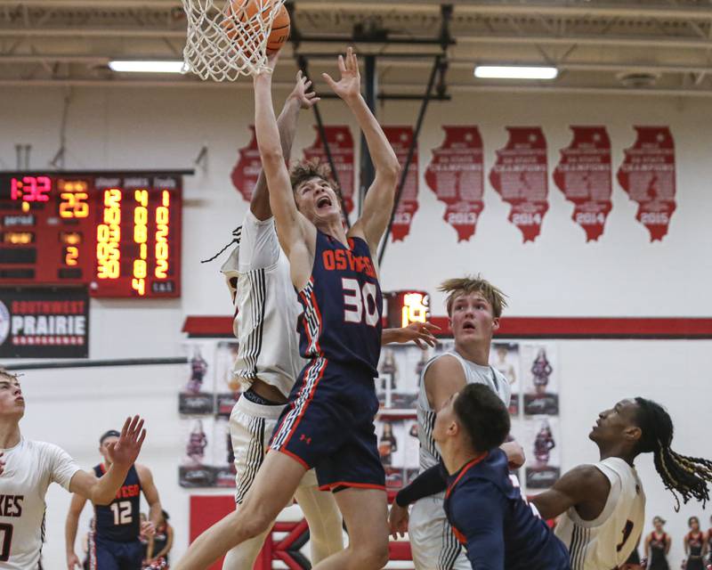 Oswego's Brayden Borrowman (30) is fouled at the basket during their basketball game between Oswego at Yorkville Friday, Dec 12, 2025 in Yorkville.