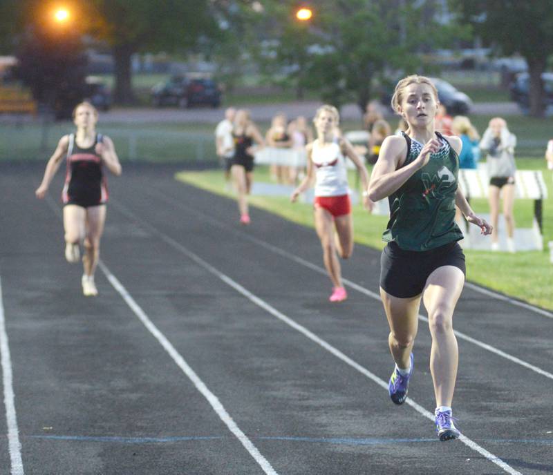 West Carroll's Emma Randecker (right) races to the finish line first followed by Oregon's Grace Tremble and Forreston's Bree Schneiderman in the final stretch of the 400 meters at the 1A Lena-Winslow sectional on Thursday, May 15, 2025. All three runners advanced to  the state meet at Eastern Illinois University in Charleston.