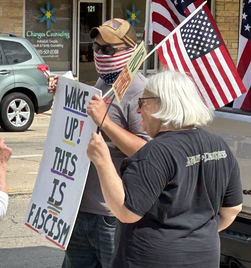 Attendees at the "No Kings" rally held in Oregon, Illinois on Saturday, June 14, 2025 hold their signs critical of the actions by President Donald Trump. An estimated 500 people attended the event, held on two sidewalks surrounding the historic Ogle County Courthouse.