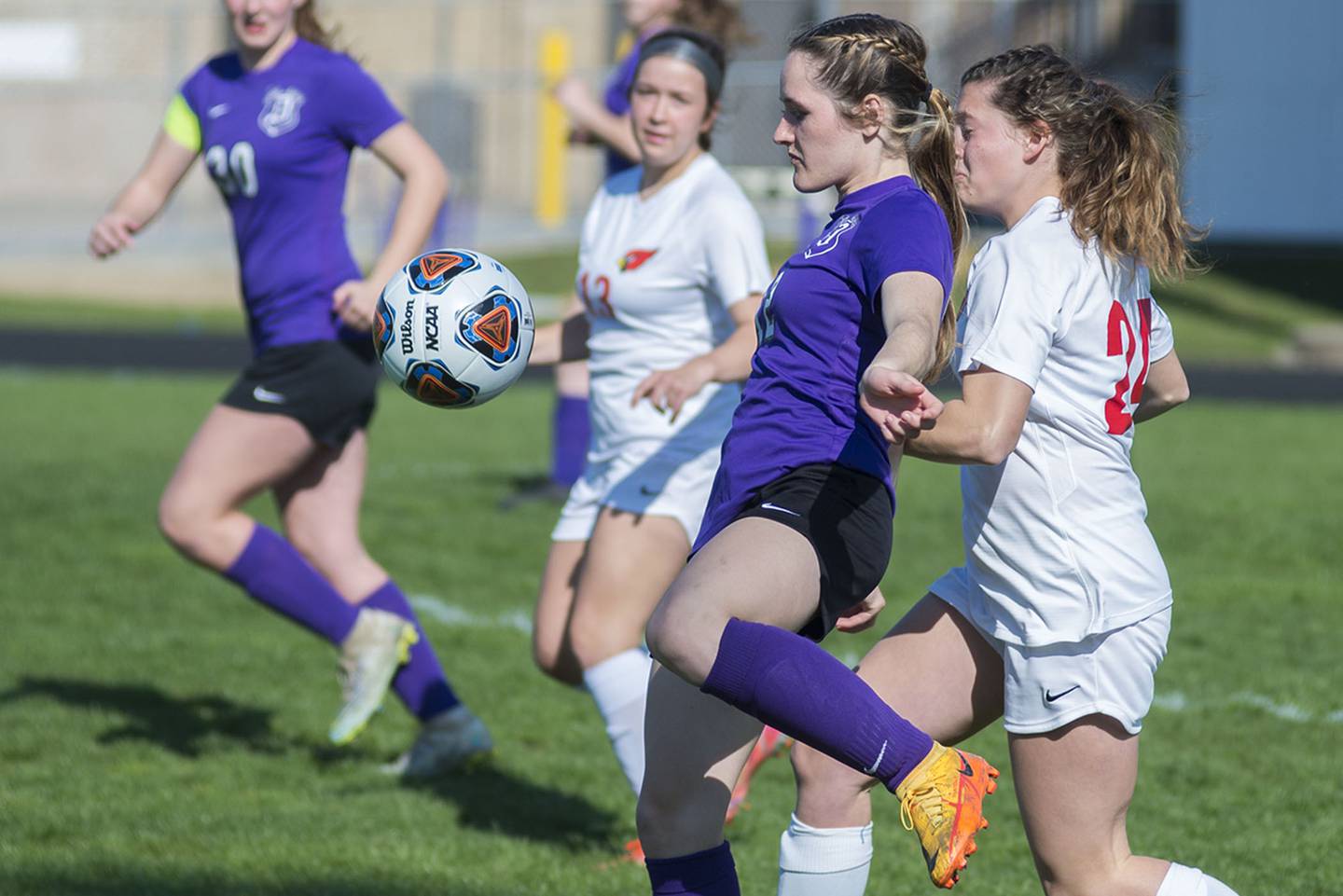 Dixon's Avery Burmeister battles Stillman Valley's Olivia Voltz for the ball Thursday, April 21, 2022.