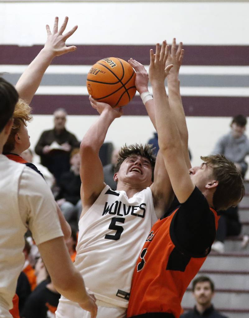 Prairie Ridge's Elijah Loeding tries to shoot over Crystal Lake Central's Grant Kuligowski during an IHSA Class 3A Prairie Ridge Regional basketball game on Monday, Feb. 24, 2025, at Prairie Ridge High School.