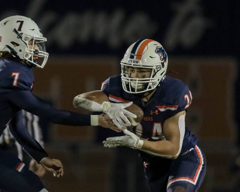 Oswego's Ayden Villa (24) takes a handoff during Class 8A second- round football game between York at Oswego on Friday, Nov 8, 2024  in Oswego.