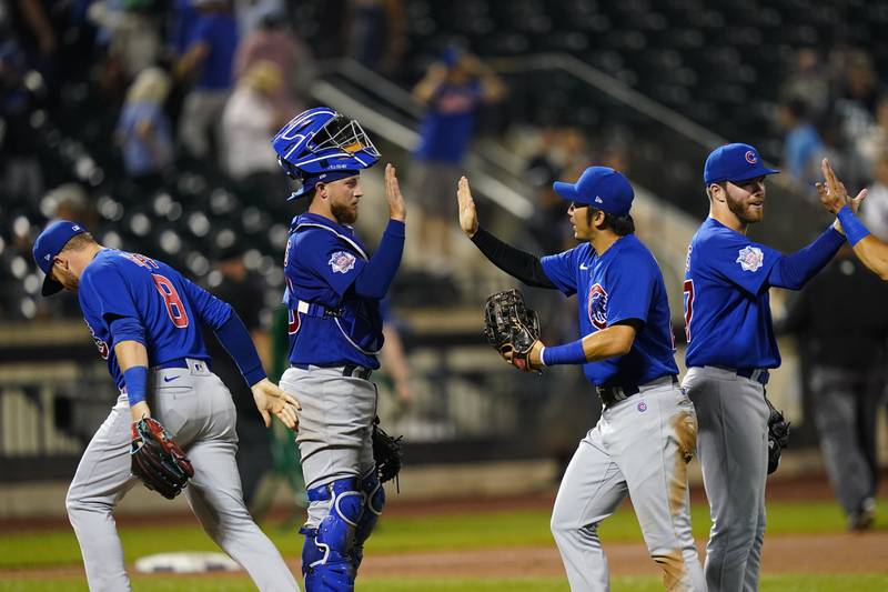 Chicago Cubs' Seiya Suzuki, of Japan, center, celebrates with teammates after a baseball game against the New York Mets Monday, Sept. 12, 2022, in New York. The Cubs won 5-2. (AP Photo/Frank Franklin II)