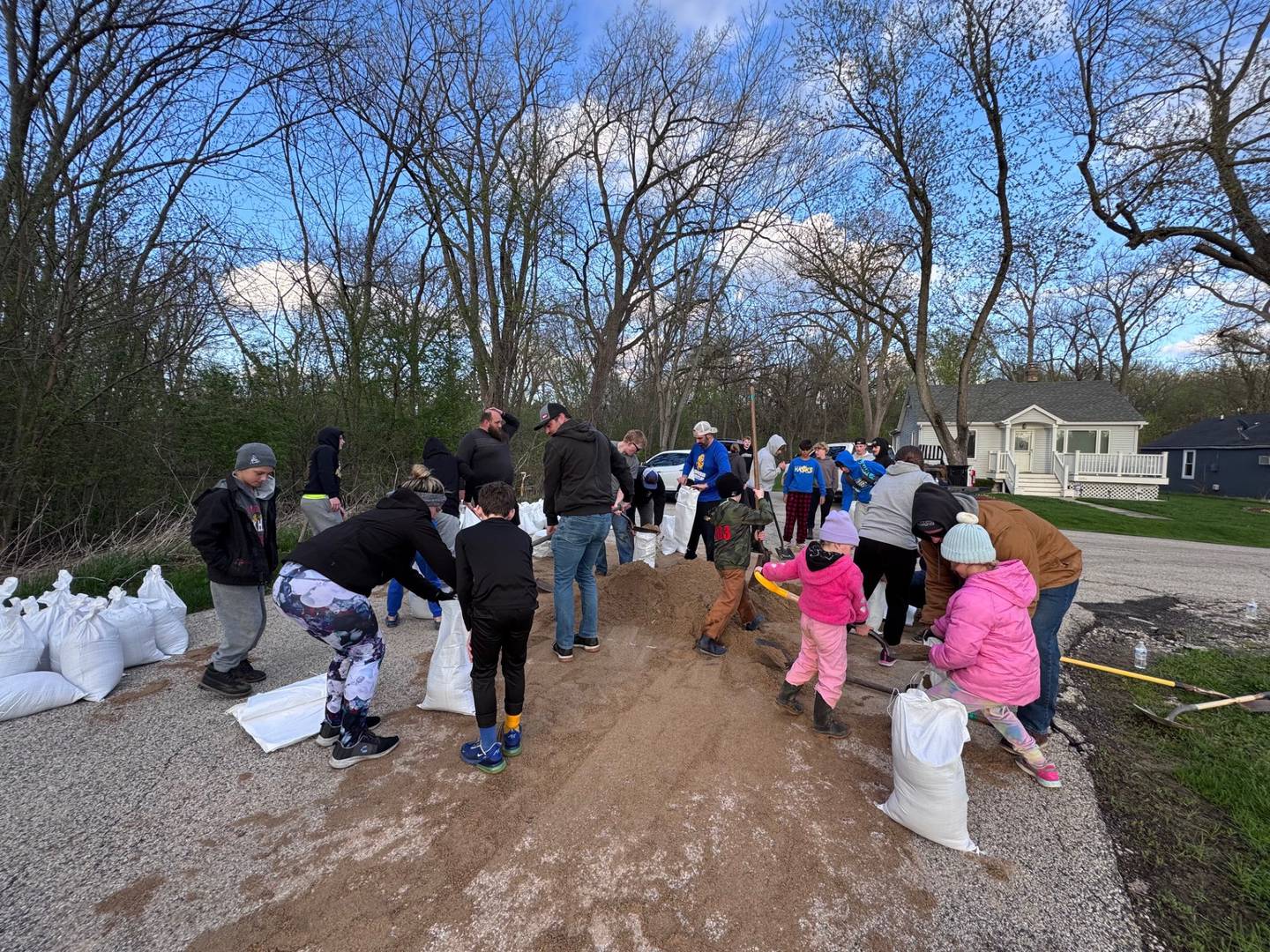 Johnsburg community comes out Saturday to help William Breit, 87, living on hospice in his home of 40 years, fill and stack sandbags as the river rises Saturday, April 18, 2026.