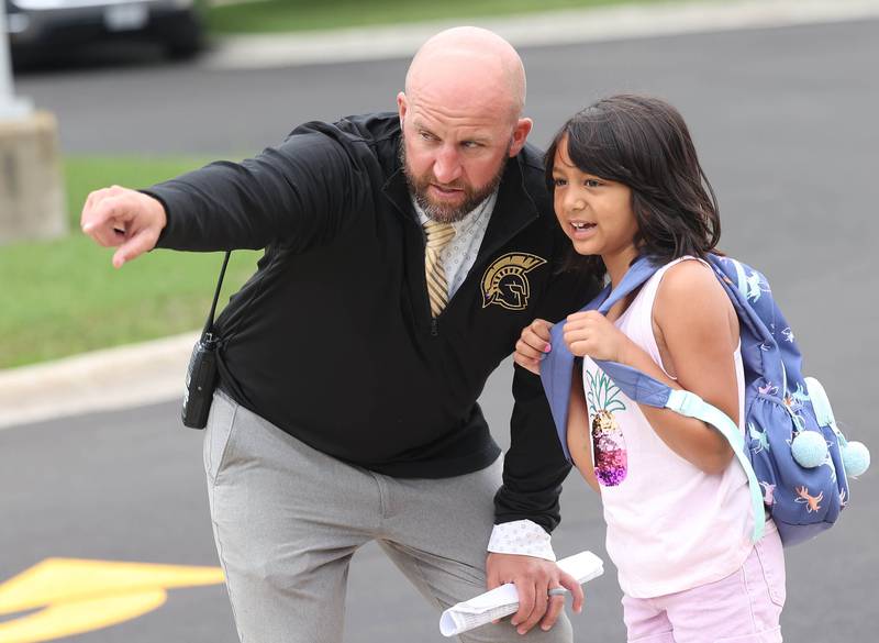 North Grove Elementary School principal Jake Countryman helps a student find her class Thursday, Aug. 21, 2025, as she arrives for the first day of school in Sycamore.