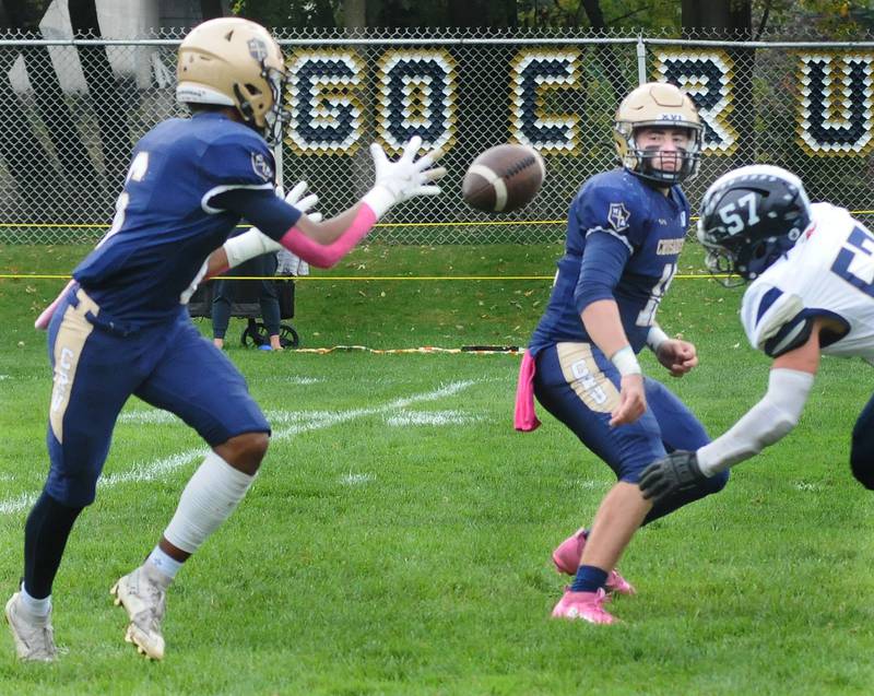 Marquette QB Anthony Couch laterals the football to teammate Connor Baker during the Crusaders' home game against Knoxville at Gould Stadium in Ottawa.