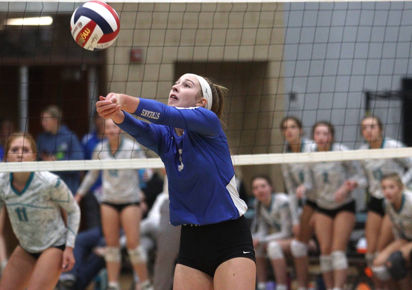 Woodstock’s Julia Laidig passes the ball in varsity volleyball at Woodstock North Monday night.