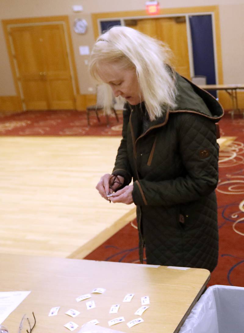 Amy Sanecki of Huntley grabs an “I Voted” sticker after casting her ballot Tuesday, April 4, 2023, in the 2023 consolidated election at Del Webb Sun City’s Prairie Lodge in Huntley.