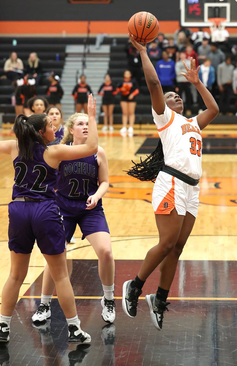 DeKalb's Cayla Evans gets between two Rochelle players for a layup during their game Monday, Nov. 28, 2022, at DeKalb High School.