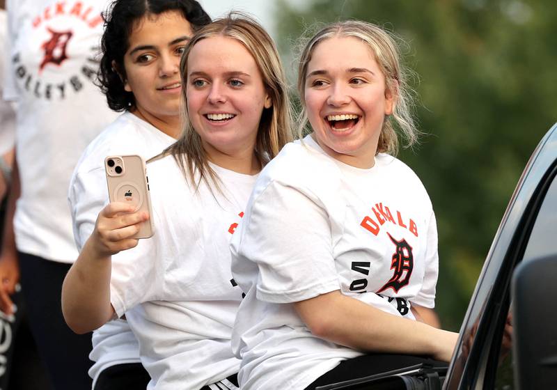 DeKalb High School volleyball players find friends among the attendees as they head down Dresser Road Wednesday, Sept. 27, 2023, during the homecoming parade.