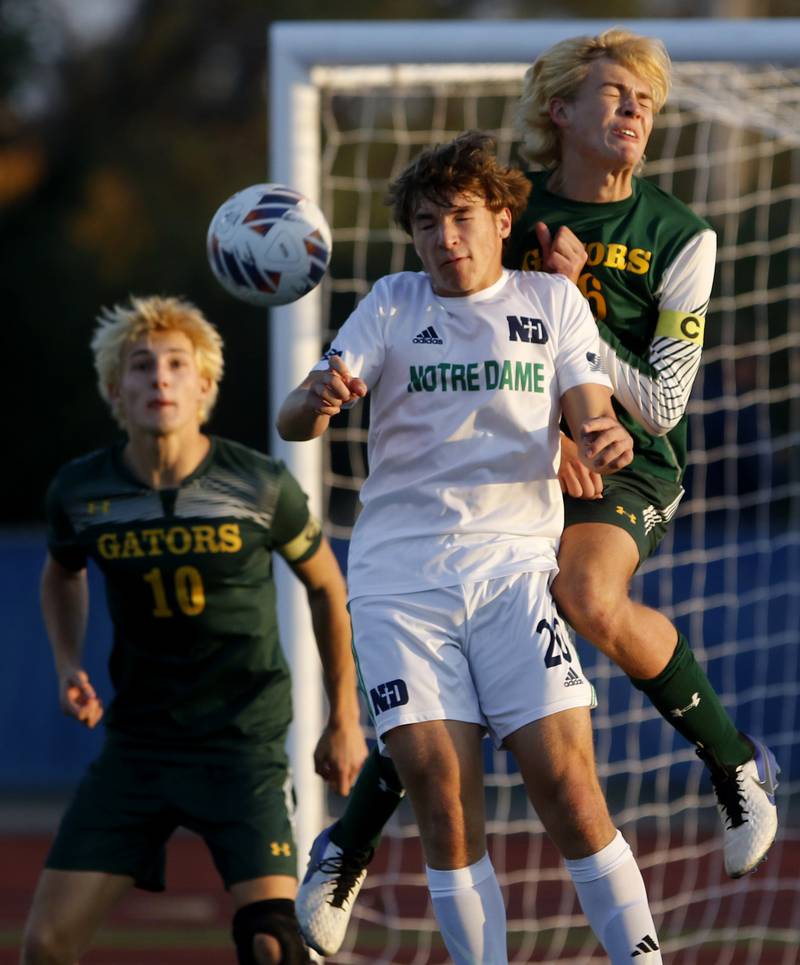 Crystal Lake South's Nolan Getzinger (left)  and his teammate, Blake Marunde tries to keep the ball away from Peoria Notre Dame's Nathan Oliver during the IHSA Class 2A state championship soccer match on Saturday, Nov. 4, 2023, at Hoffman Estates High School.