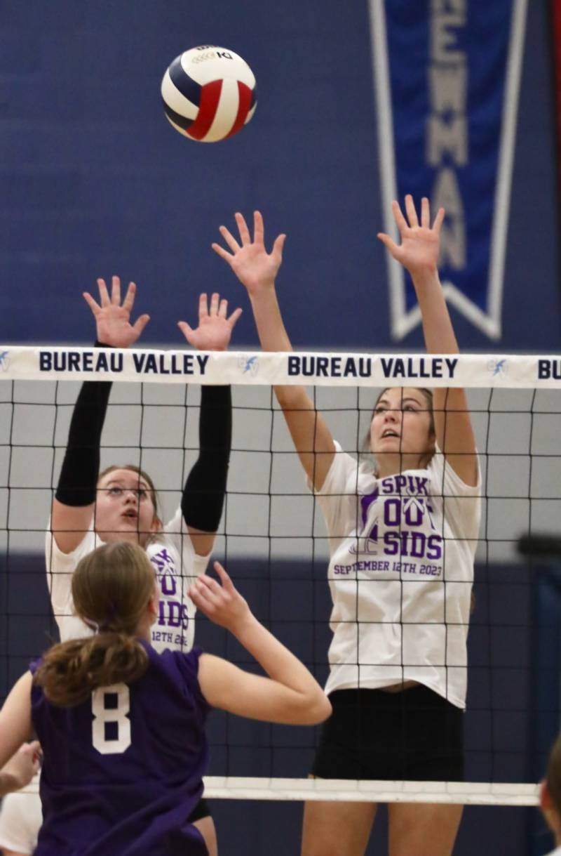 Princeton's Natasha Faber-Fox (left) and Chrissy Sierens defend the net against Bureau Valley's Taylor Neuhalfen Tuesday night at the Storm Cellar.