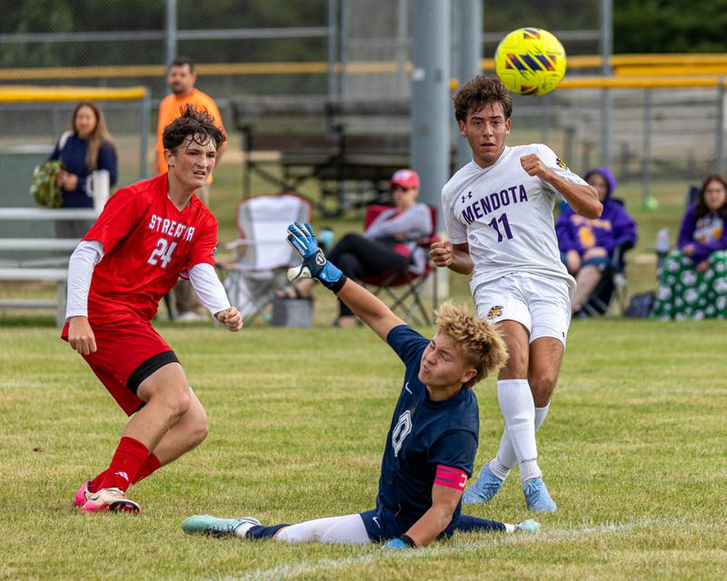 (from left) Keegan Gassman (24) of Streator watches on as teammate and goalkeeper Seth Zito (0) unsuccessfully blocks kick from Cesar Casas (11) of Mendota resulting in goal on Saturday, Aug 30, 2025 at the James Street Recreation Area in Streator.