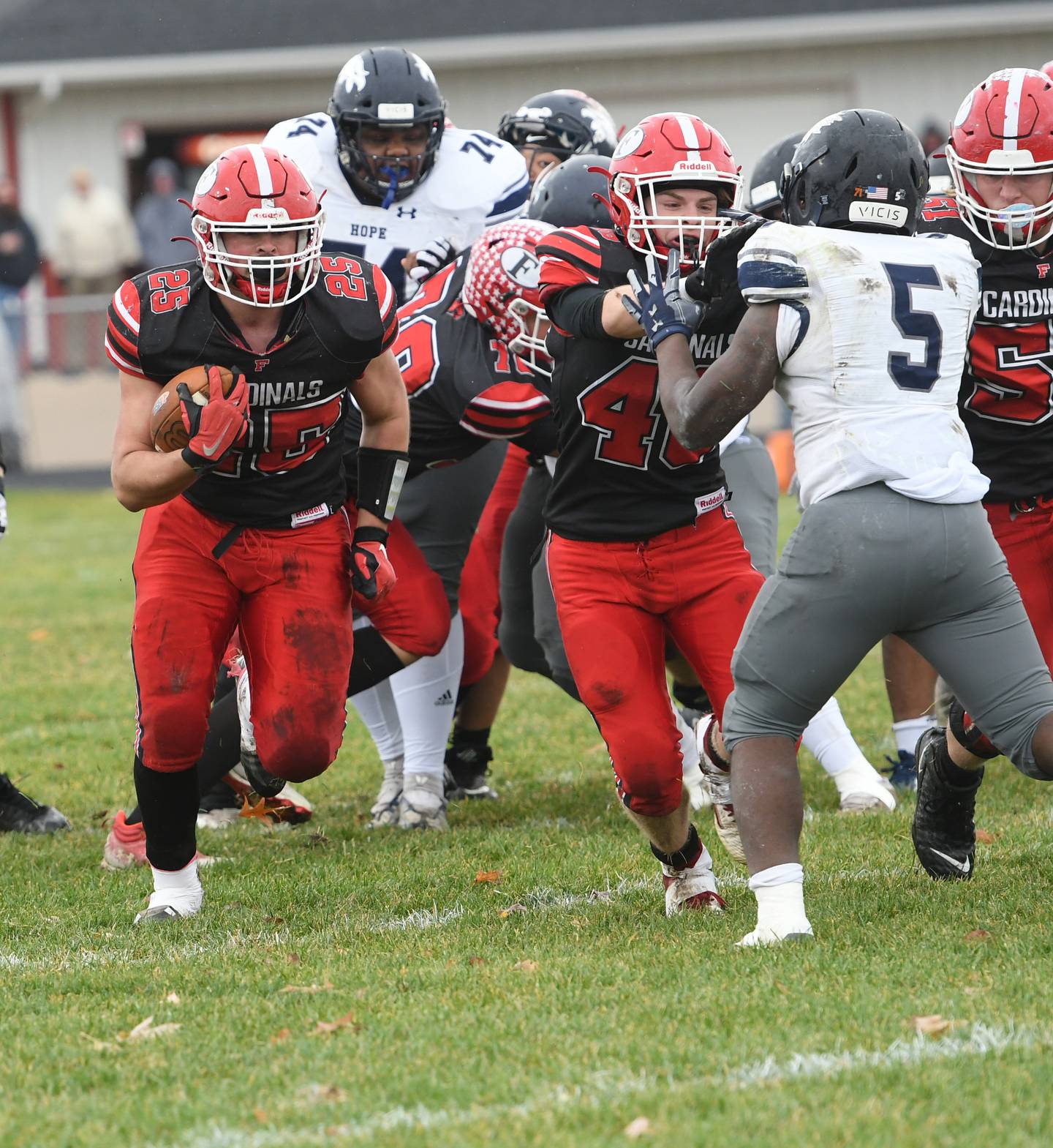 Forreston's Johnathen Kobler (25) looks for running room as he gets a block from Colin Kuhn during the Cardinals' 44-16 playoff win over Chicago Hope Acaademy on Saturday, Nov. 5.