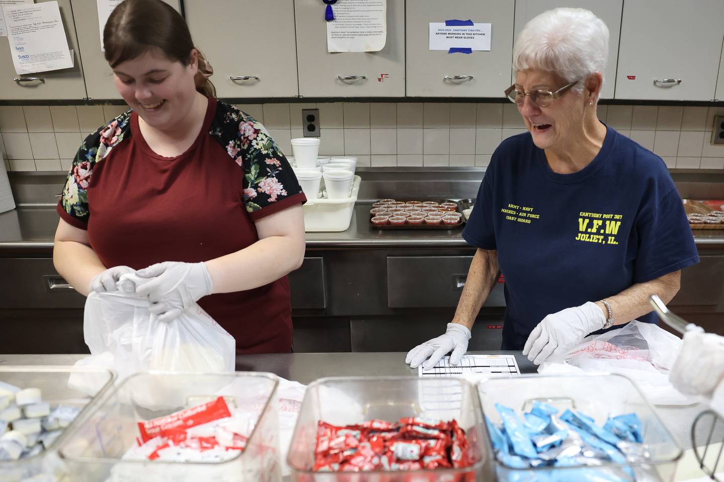 Danielle Redmon, left, and her grandmother Donna Redmon prepare a fish dinner order at the VFW Cantigny Post 367 in Joliet on Friday, Oct. 20.