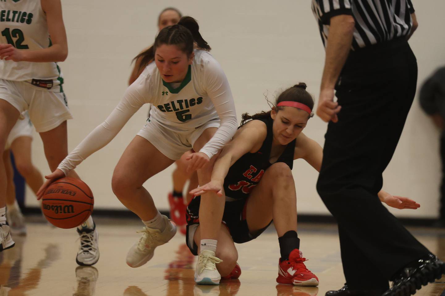 Providence’s Sydney Spencer wins the loose ball battle against Glenbard East’s Veronica Witt in the 2022 Carl Sandburg Girls Basketball Holiday Classic.