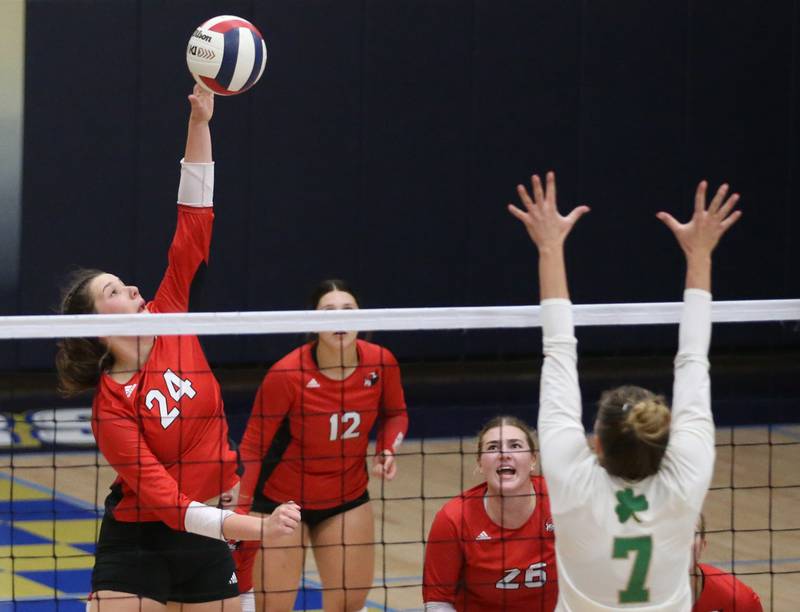 Henry-Senachwine's Harper Schrock spikes the ball past Seneca's Audry McNabb during the Tri-County Conference Championship game on Thursday, Oct. 17, 2024 in Bader Gym at Marquette High School.