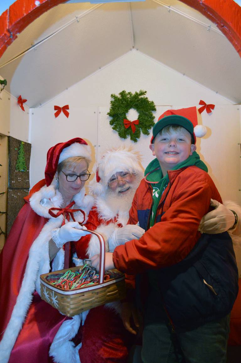 Spencer Nelson, 11, of Polo, sits with Santa and Mrs. Claus to share his wish list on Dec. 3, 2022, as part of the fourth annual Polo Christmas Festival.
