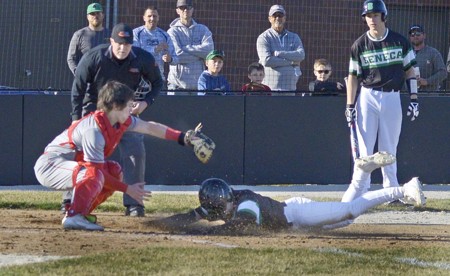 Seneca’s Casey Clennon slides in under the tag of Ottawa’s Adan Swanson to score the first run in the 3rd inning Monday at Seneca.