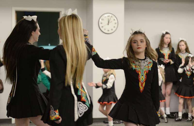 Trinity Irish Dancers (left-right) Julia VanWyck, Rhiann Zulfer, and Colleen Robertshaw celebrate St. Patrick's Day at the Downers Grove Library Saturday, March 16, 2024.