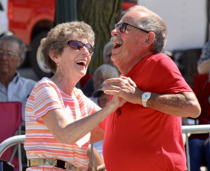 A couple dances during the performance of Lyle Grobe and the Rhythm Ramblers on Sunday in front of the Stella main stage at the Dixon Petunia Festival.