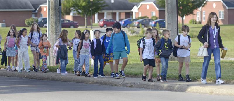 A long line of students make their way up a sidewalk Wednesday as they begin the first day of school at Centennial Wednesday in Streator.