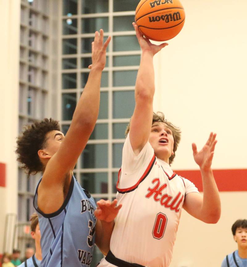 Hall's Greyson Bickett runs in front of Bureau Valley's Dakarai Martin to score in the paint on Wednesday, Jan. 28, 2026 at Hall High School.