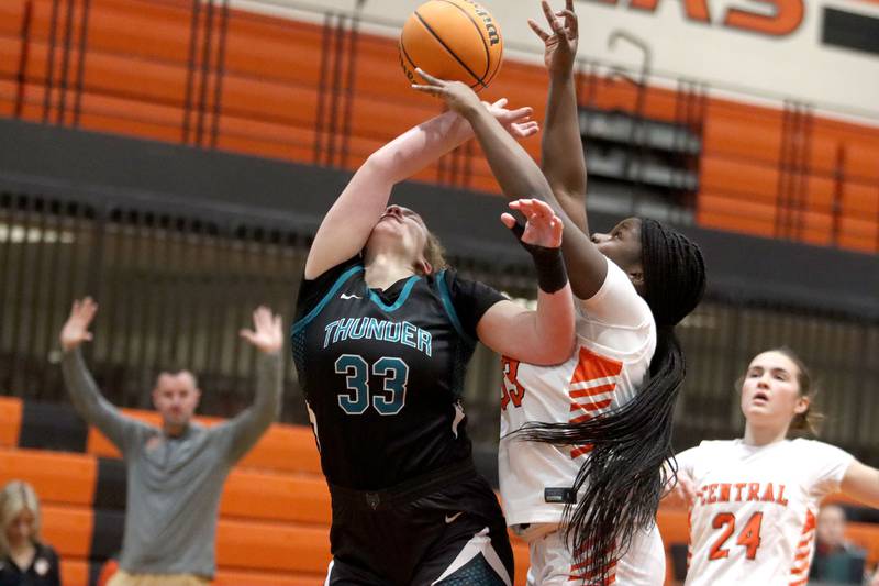 Crystal Lake Central’s Pekun Bolarin, center right, tussles with Woodstock North’s Jade Slinko, center left, in varsity girls basketball on Monday, Jan. 26, 2026, at Crystal Lake Central High School in Crystal Lake.