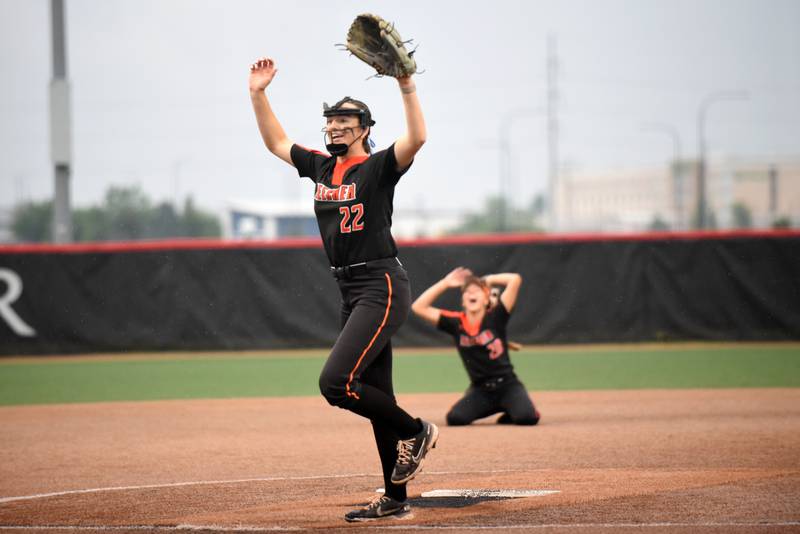 Beecher's Taylor Norkus lifts her arms in triumph as Ava Olson drops to her knees after Norkus recorded the final out of the Bobcats' 5-2 10-inning win over Carterville in the Class 2A State championship game at Peoria's Louisville Slugger Complex Saturday, June 7, 2025.