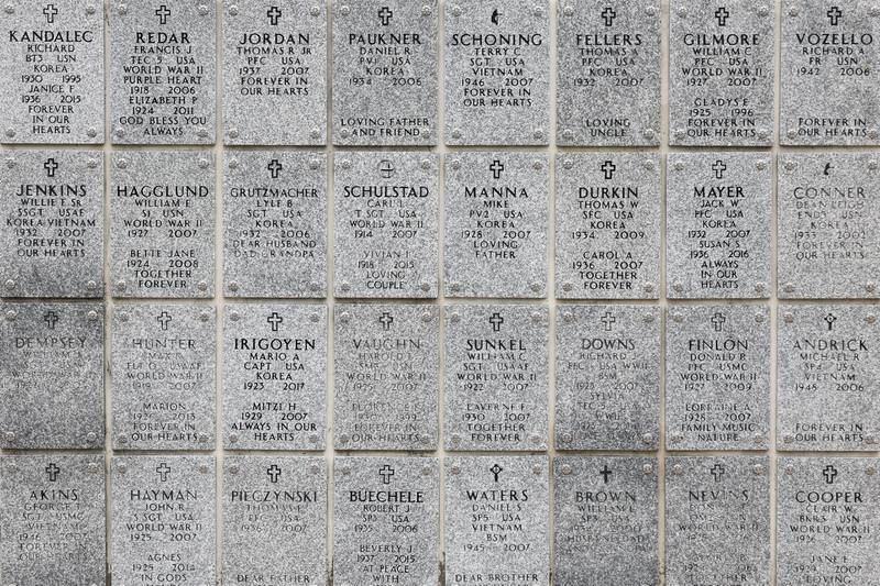 Plaques of members of the armed forces hang on the columbarium at the Abraham Lincoln National Cemetery in Elwood on Saturday, July 29.