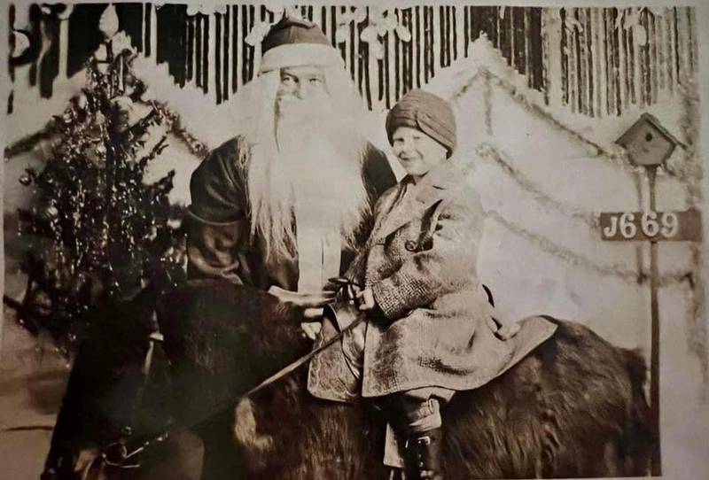 Edward Johnson of Joliet enjoys a visit with Santa while sitting on top of a horse around 1930.