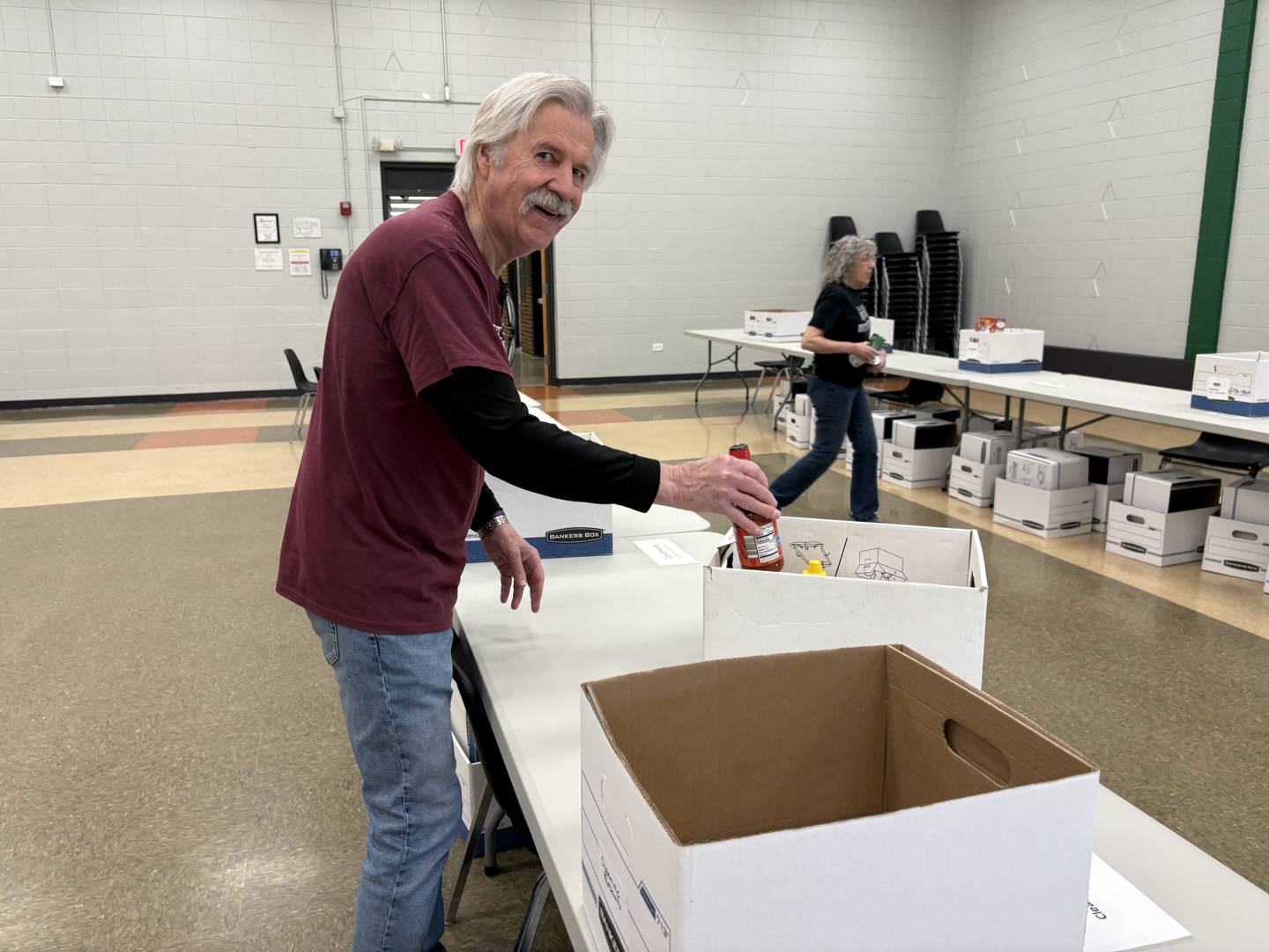 Grafton Food Pantry Volunteer Hans Stucki sorts hot sauce at the Huntley Park District Saturday May 9, 2026.