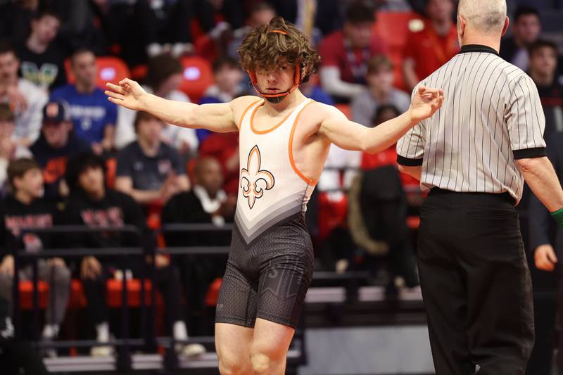 St. Charles East’s Ben Davino celebrates his win over Marmion’s Jameson Garcia in the 126-pound Class 3A championship match on Saturday, Feb. 18, 2023 at State Farm Center in Champaign.