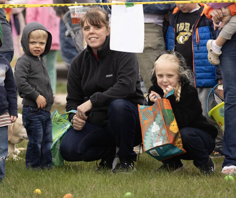 Katie Miller of Ottawa waits with her children, Alex, who was celebrating his third birthday, and Lily, 7, for the official start to the egg hunt during the Hurray for Spring event Saturday, March 30, 2024, in Ottawa's Jordan block.