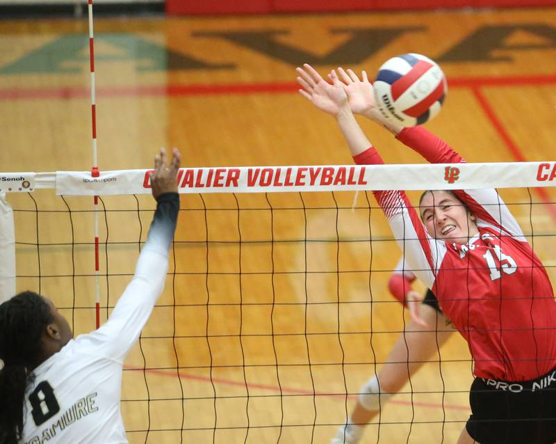Sycamore's Khiara Thomas has her kill deflected by L-P's Drew Depenbrock on Tuesday, Sept. 23, 2025 in Sellett Gymnasium at L-P High School.