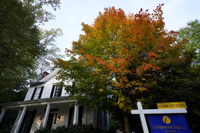 A real estate sign is seen near a home on the market, Wednesday, Oct. 12, 2022, in Towson, Md. Any Americans hoping for relief from months of punishing inflation might not see much in an upcoming government report on price increases in September.  (AP Photo/Julio Cortez)