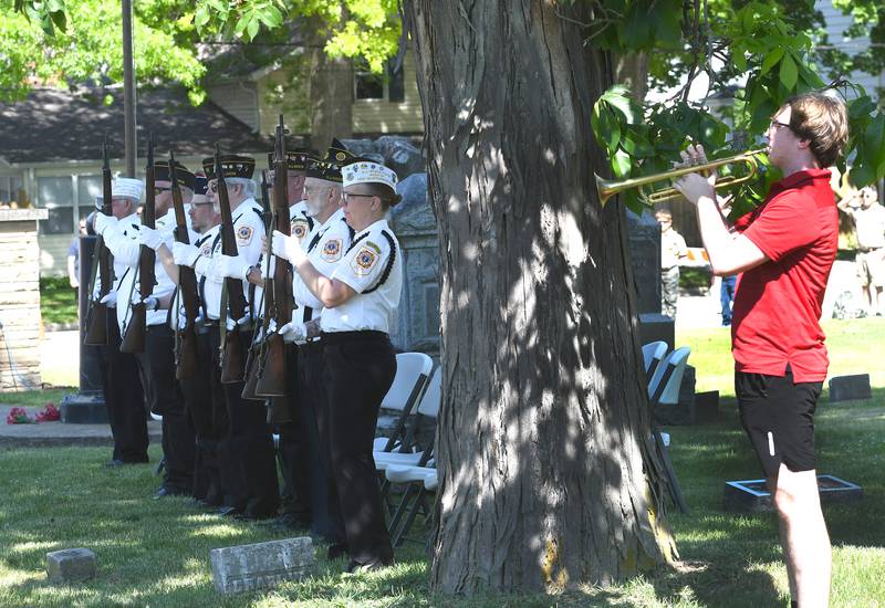 Members of the Oregon VFW stand at attention as Oregon High School band member Cole Hoversten plays taps during Oregon's Memorial Day Service on Monday, May 25, 2026 at the Riverside Cemetery. Hoversten and Sarah Eckardt both played trumpets to create "Echo Taps" with the buglers standing some distance apart to achieve an echo effect.