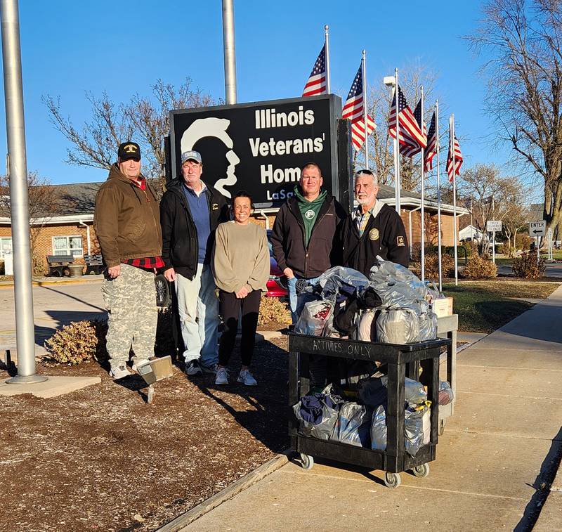 Wenona American Legion Post 8 made its annual Christmas donations to the Illinois Veterans Home in La Salle. Pictured are (from left) James “Tiger” Lauf, Jeff “Milkman” Blessington, Veterans Home Activity Aide Kassie Seaborn, Edward Harezlak and Dale Peters.