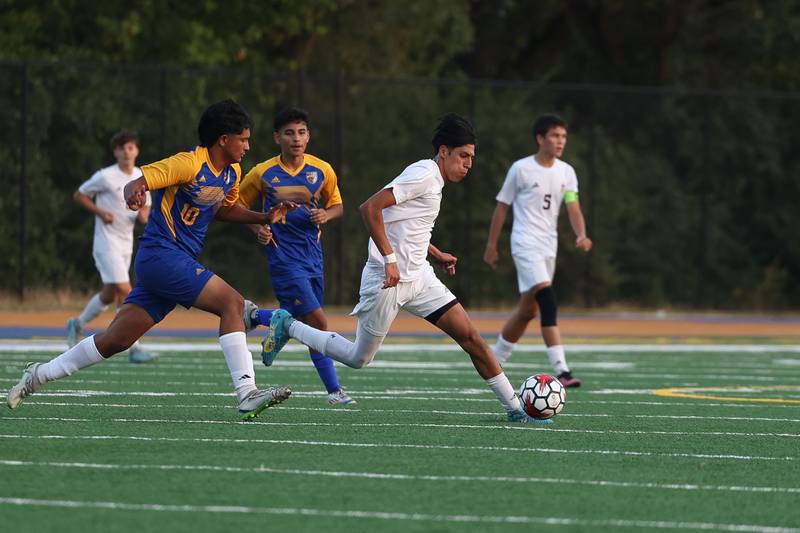 Joliet Catholic’s Leonardo Marquez works the ball midfield against Joliet Central on Monday, Sept. 9, 2024 in Joliet.