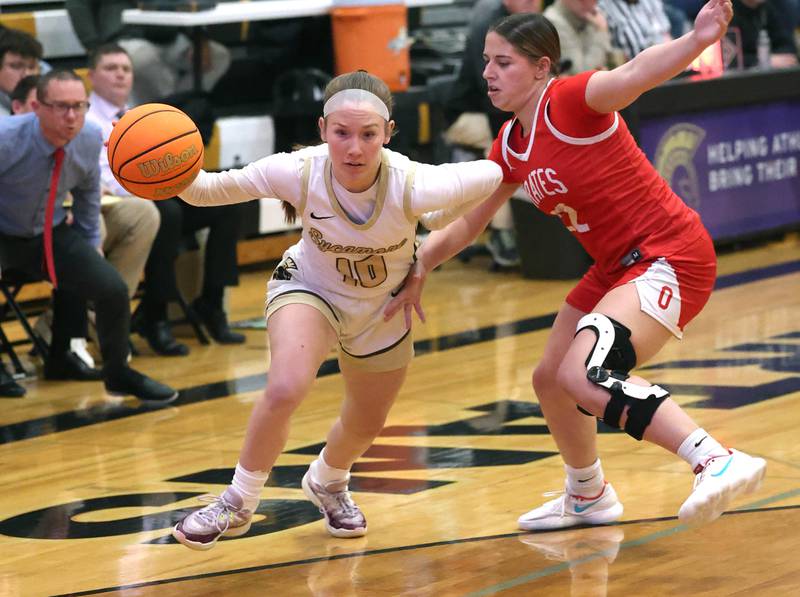Sycamore's Cortni Kruizenga tries to drive by Ottawa's Marlie Orlandi during their game Friday, Jan. 10, 2025, at Sycamore High School.