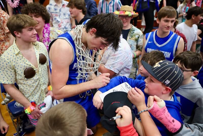 Princeton senior Noah LaPorte signs autographs for his young admirers following Friday's regional championship victory over Seneca.