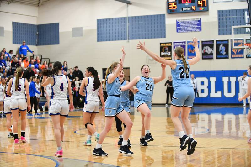 Cissna Park's Josie Neukomm (22) rushes to celebrates with teammates as the Timberwolves claimed the IHSA Class 1A Blue Ridge Super-Sectional title with a 47-35 victory over St. Teresa on Monday, March 3.