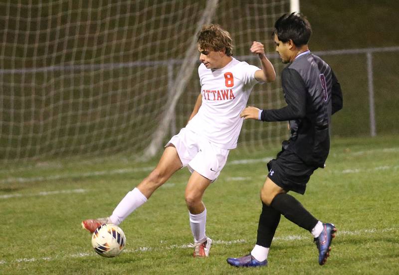 Ottawa's Maddox Mathews kicks the ball away from Kankakee's Joseph Andrade during the Class 2A Regional semifinal game on Monday, Oct. 20, 2025 at Ottawa HIgh School.
