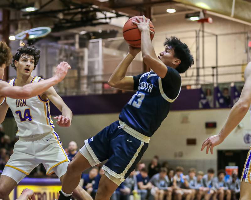 Downers Grove South's Richard Gasmen (13) puts up an off balanced shot during basketball game between Downers Grove South at Downers Grove North. Dec 16, 2023.