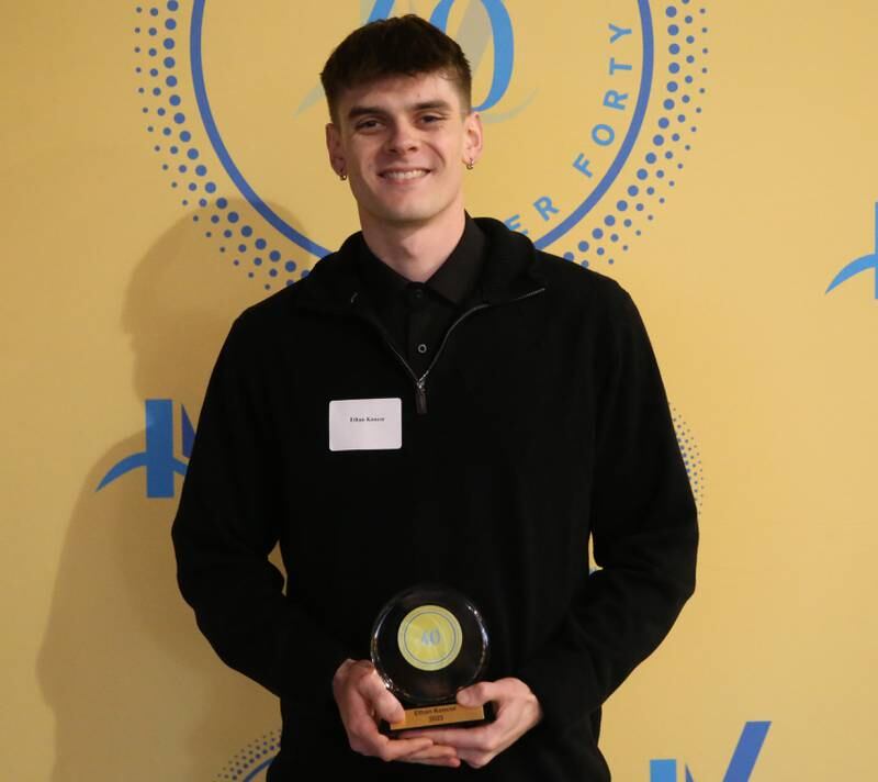 Ethan Koncor poses for a photo with his award during the 40 Under Forty awards banquet on Thursday, March 21, 2024 at Westclox in Peru.
