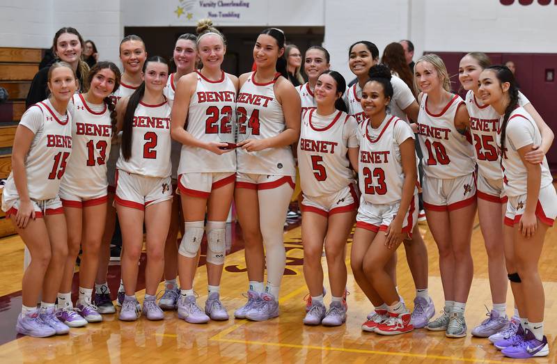 The Benet Academy girls basketball team pose with their Montini Christmas Tournament championship trophy held by Bridget Rifenburg (22) and Emma Briggs (24) after defeating Marist on December 27, 2025 at Montini Catholic High School in Lombard.
