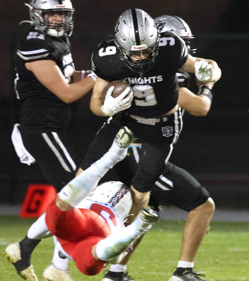 Kaneland's Carter Grabowski hurdles Lakes' Anthony Perna Saturday, Nov. 1, 2025, during their first round playoff game at Kaneland High School in Maple Park.